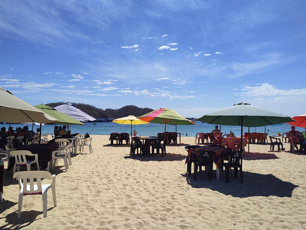 Tables on the sand at Playa Santa Cruz, Mexico.