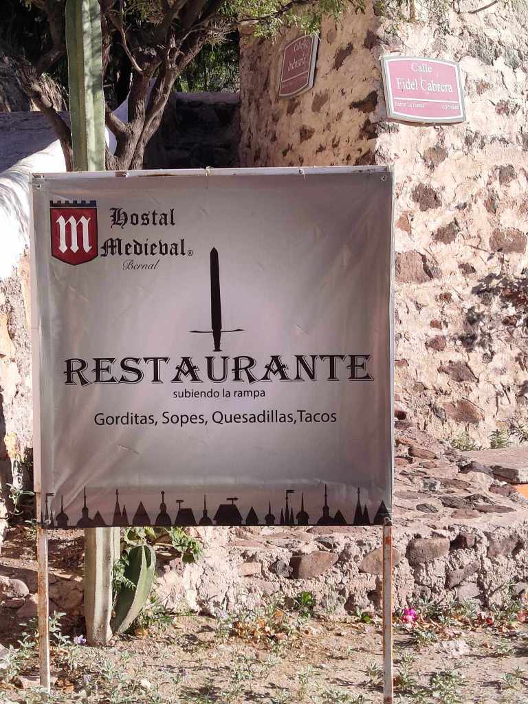 Sign for the 'Hostal Medieval' hostel and restaurant.
