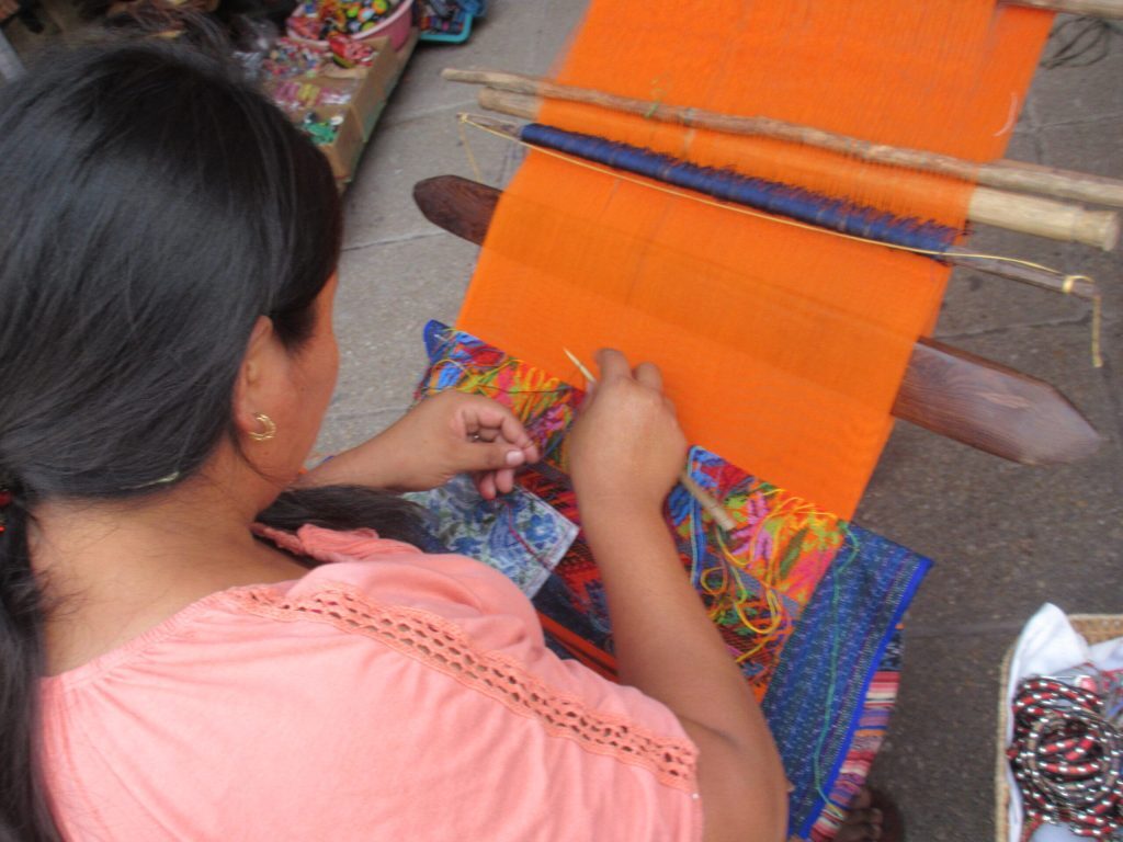 Indigenous woman making handmade traditional art