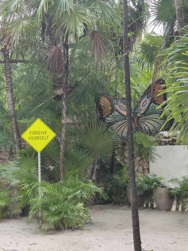 Sign and butterfly at Ahua Hotel