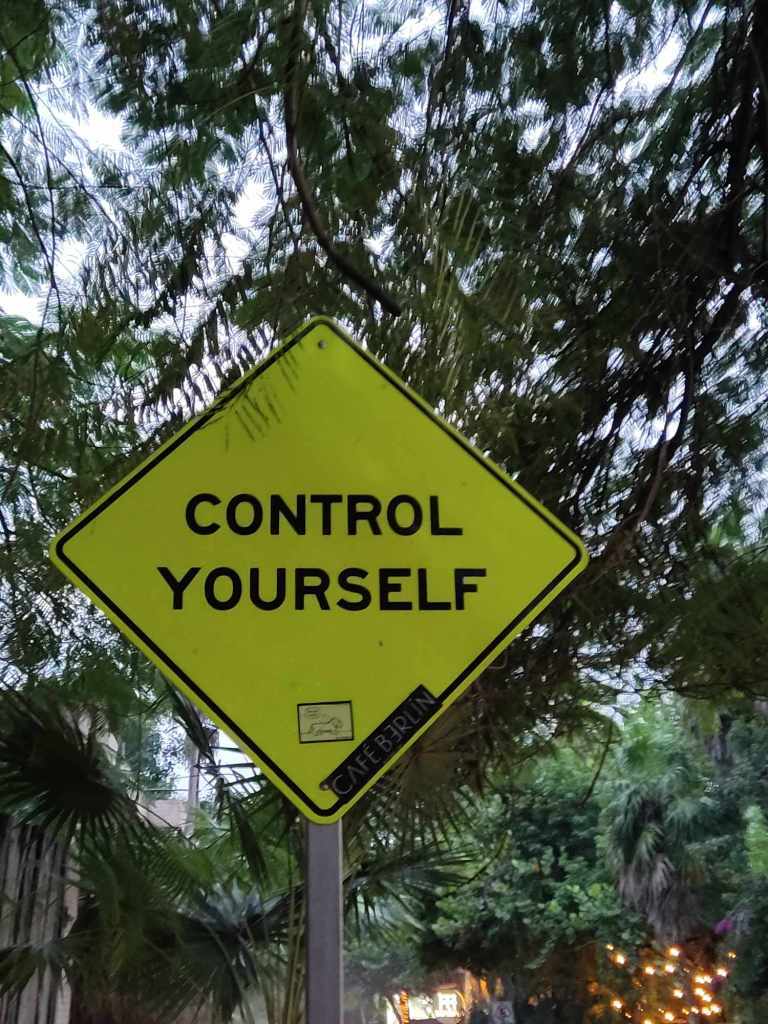 Control yourself Sign outside of the Ahau sculpture park