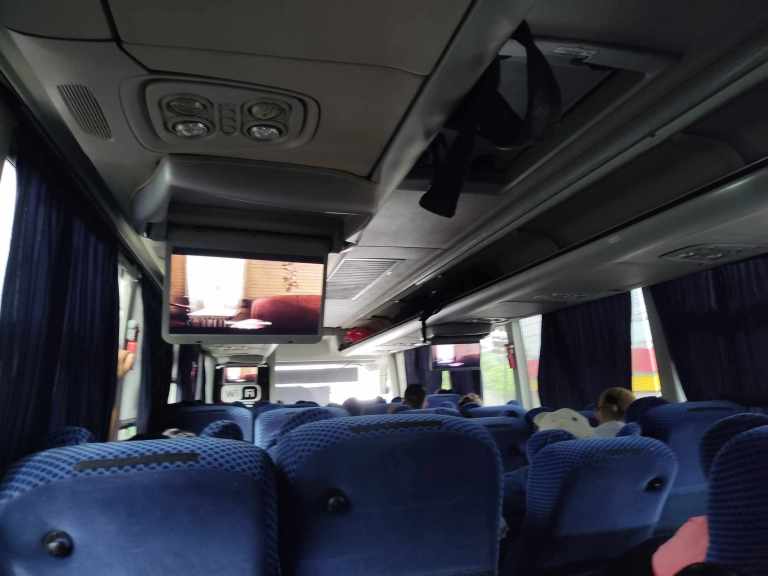 Inside of a bus in Mexico with a movie playing